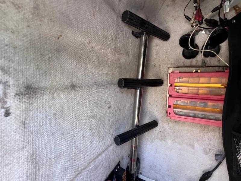 Slide: The Image of 2005 Hydra-Sports Vector 2400 CC interior with rod holders and battery compartment. - 27