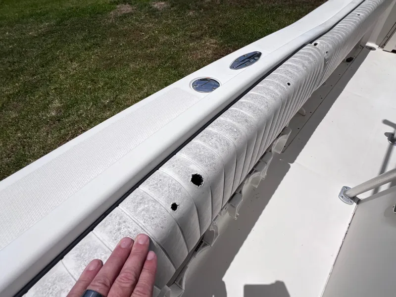 Slide: The Image of 2005 Hydra-Sports Vector 2400 CC boat interior with worn upholstery and visible damage. - 33