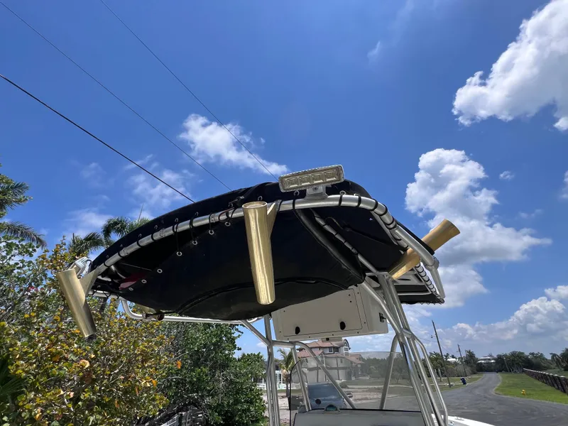 Slide: The Image of 2005 Hydra-Sports Vector 2400 CC boat with T-top under clear blue sky. - 35