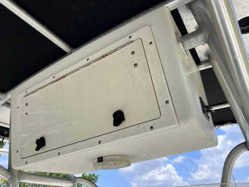 Slide: The Image of 2005 Hydra-Sports Vector 2400 CC storage compartment under T-top, clear sky background. - 39