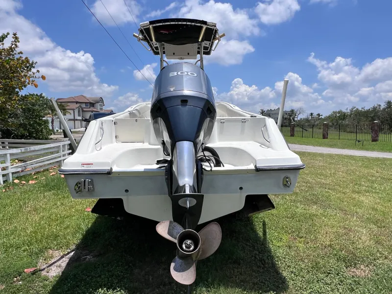 Slide: The Image of 2005 Hydra-Sports Vector 2400 CC boat, rear view, on grass under a blue sky. - 4