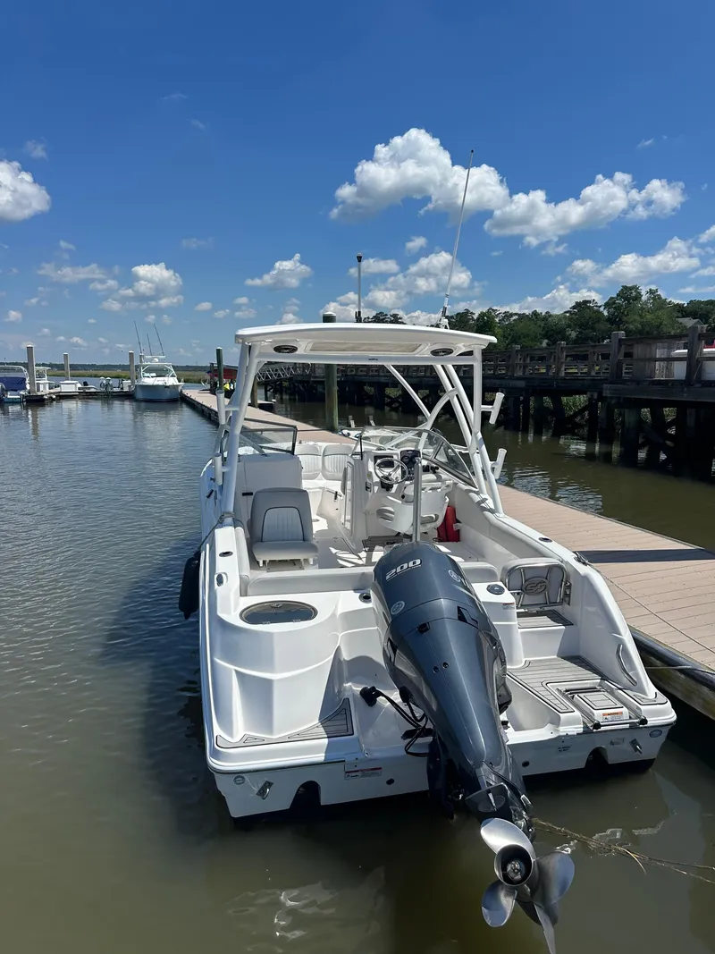 Slide: The Image of 2024 Sea Fox 226 Traveler boat docked under a clear blue sky. - 12