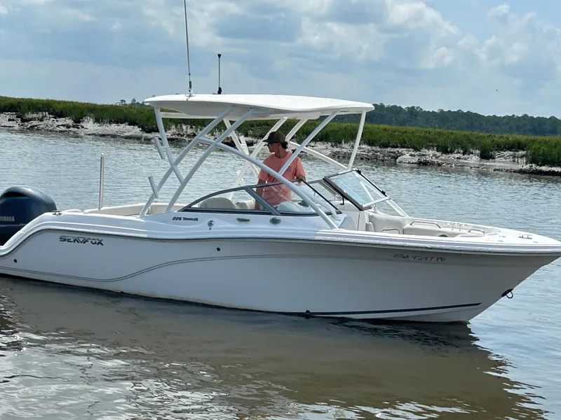 Slide: The Image of 2024 Sea Fox 226 Traveler boat on calm water under a cloudy sky. - 6