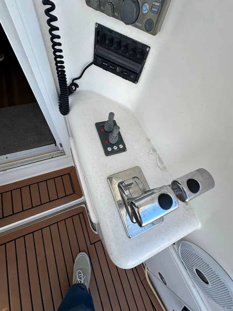 Slide: The Image of Control panel of a 2003 Riviera 37 Flybridge yacht with throttle and joystick. - 11