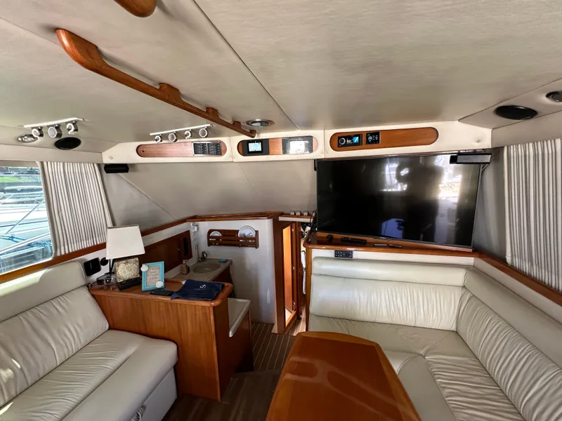 Slide: The Image of Interior of 2003 Riviera 37 Flybridge yacht with leather seating and modern amenities. - 12