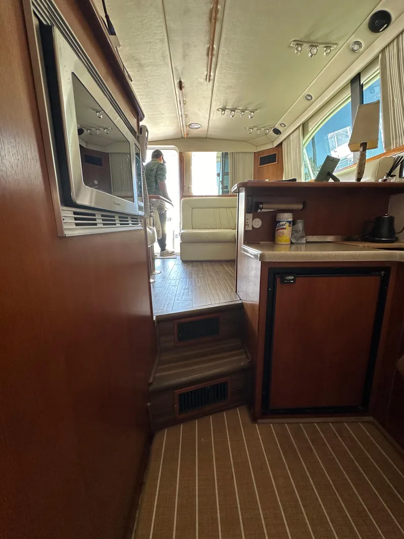 Slide: The Image of Interior of 2003 Riviera 37 Flybridge yacht with wood finish and modern amenities. - 17