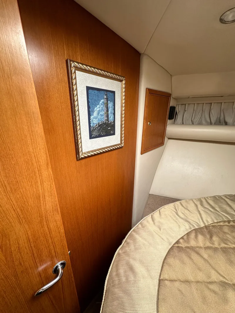 Slide: The Image of Interior of 2003 Riviera 37 Flybridge with wood paneling and framed artwork. - 21