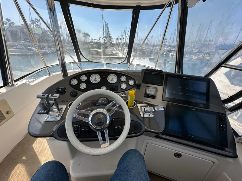 Slide: The Image of Cockpit view of 2003 Riviera 37 Flybridge yacht with steering wheel and navigation instruments. - 3