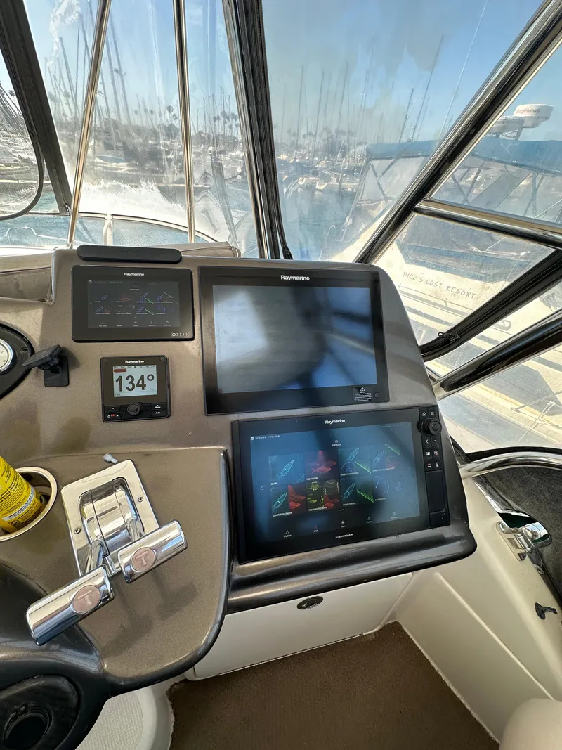 Slide: The Image of Control panel of 2003 Riviera 37 Flybridge with navigation screens and throttle controls. - 6