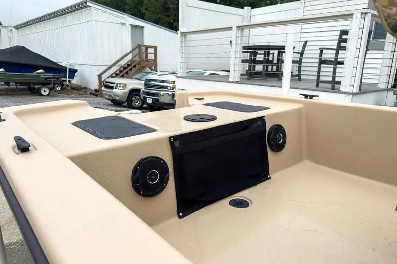 Slide: The Image of 2026 Carolina Skiff E20 JVX CC Sportsman boat interior with speakers and storage. - 12