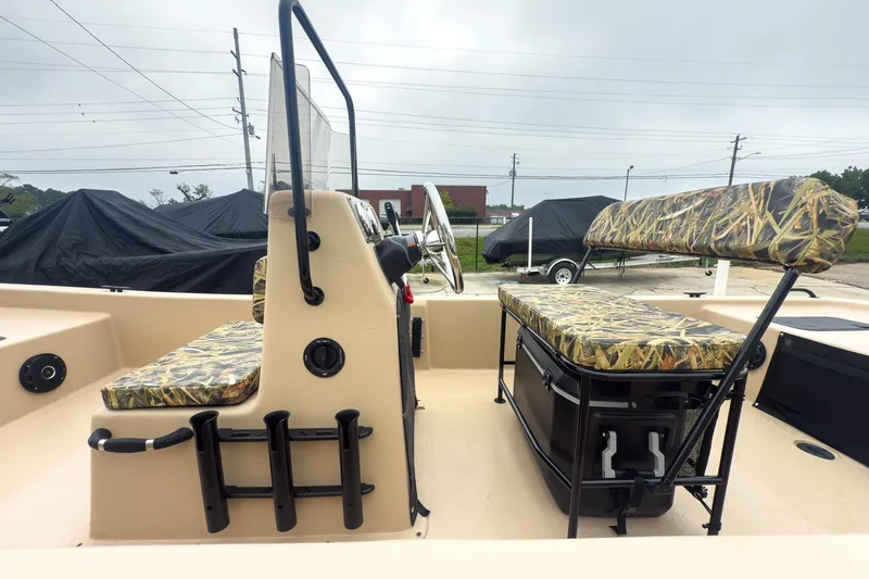 Slide: The Image of 2026 Carolina Skiff E20 JVX CC Sportsman boat interior with camouflage seating and console. - 16