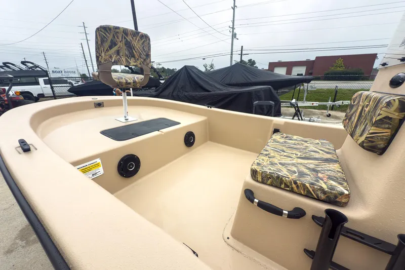 Slide: The Image of 2026 Carolina Skiff E20 JVX CC Sportsman boat interior with camo seats and spacious deck. - 19