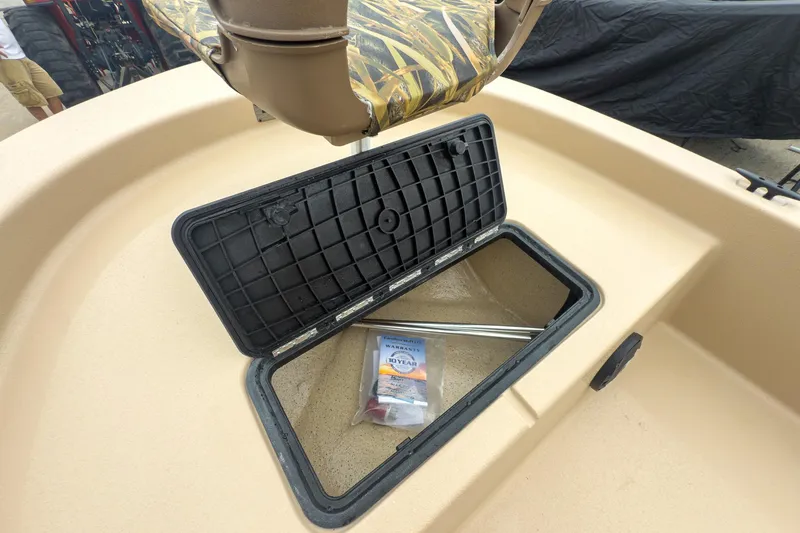 Slide: The Image of 2026 Carolina Skiff E20 JVX CC Sportsman boat storage compartment open, revealing interior. - 20