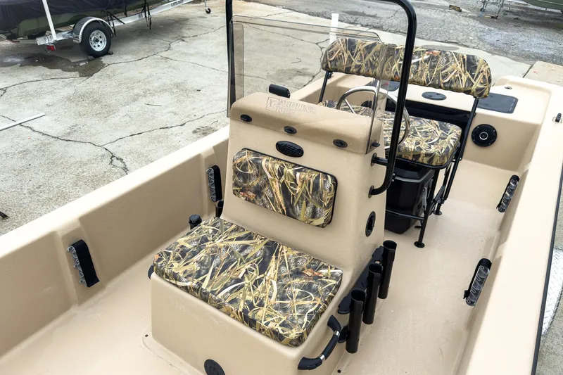 Slide: The Image of 2026 Carolina Skiff E20 JVX CC Sportsman boat with camouflage seating and console. - 23