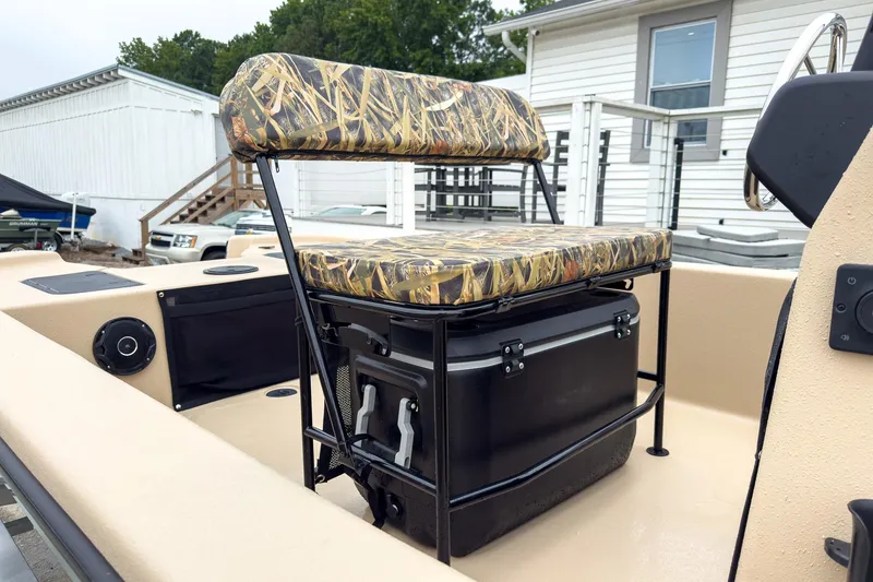 Slide: The Image of 2026 Carolina Skiff E20 JVX CC Sportsman boat with camo seating and storage. - 5