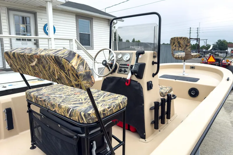 Slide: The Image of 2026 Carolina Skiff E20 JVX CC Sportsman boat with camo seating and steering console. - 6