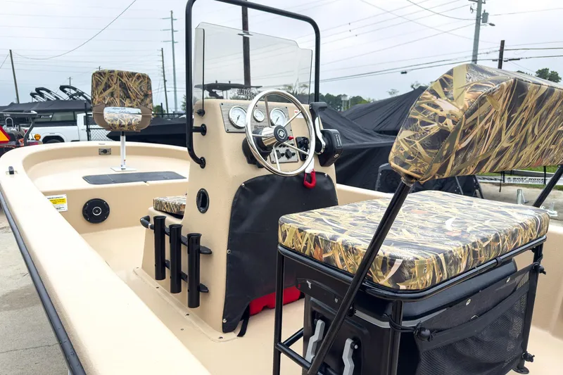 Slide: The Image of 2026 Carolina Skiff E20 JVX CC Sportsman boat with camo seats and steering console. - 7