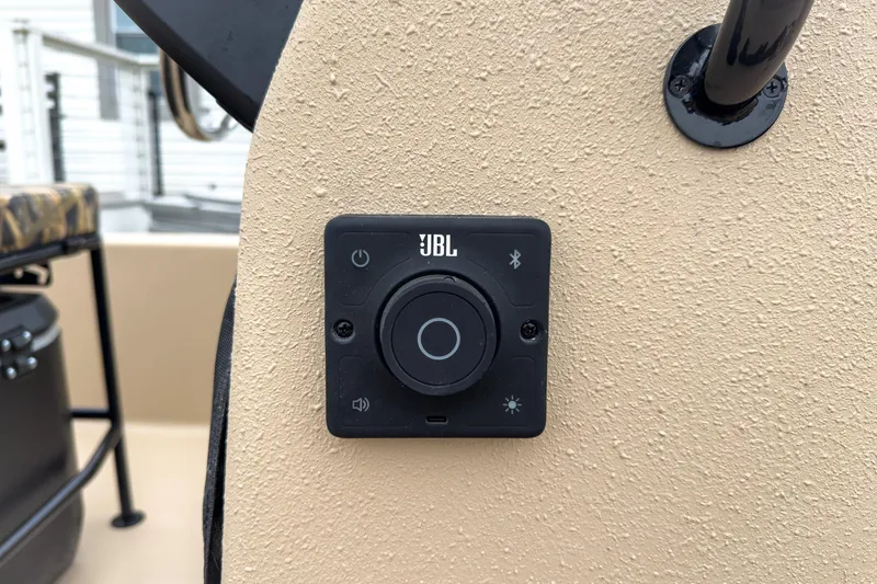 Slide: The Image of JBL control panel on 2026 Carolina Skiff E20 JVX CC Sportsman boat dashboard. - 9