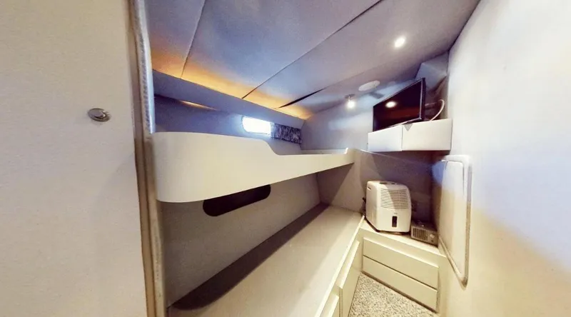 Slide: The Image of Cozy cabin interior of 1991 New York Yachts 88 with bunk beds and TV. - 15