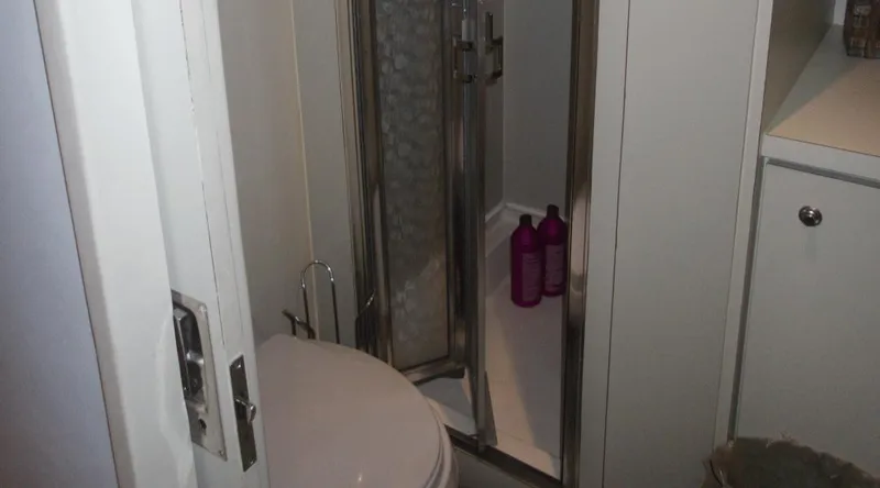 Slide: The Image of Compact yacht bathroom with shower, toilet, and toiletries. New York Yachts 88, 1991 model. - 16
