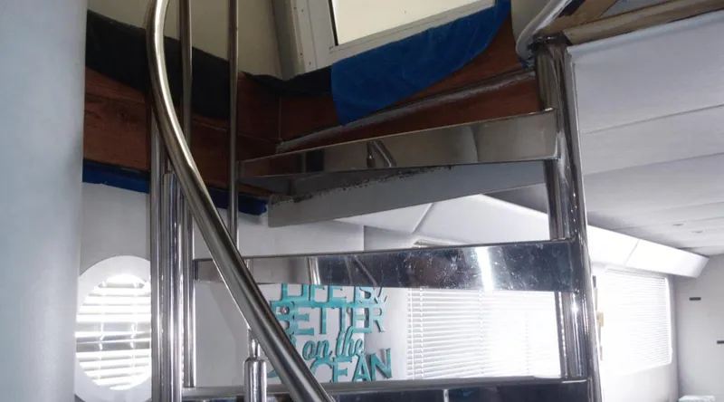 Slide: The Image of Spiral staircase inside 1991 Custom New York Yachts 88, featuring sleek metal design. - 19