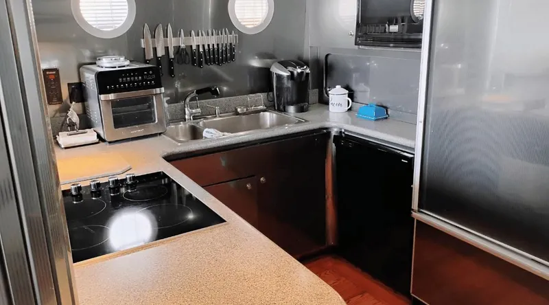 Slide: The Image of Modern yacht kitchen with appliances, knife set, and porthole windows on New York Yachts 88, 1991. - 20