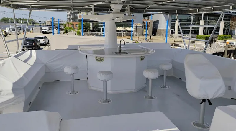 Slide: The Image of Luxurious 1991 Custom New York Yachts 88 deck with bar and seating area. - 26