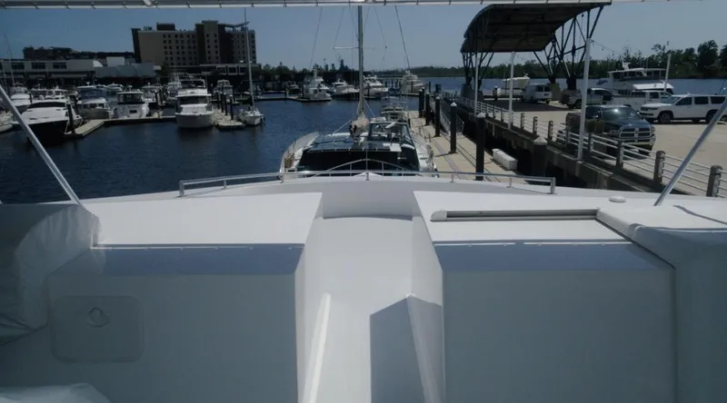 Slide: The Image of Luxurious 1991 Custom New York Yachts 88 docked at a bustling marina. - 28