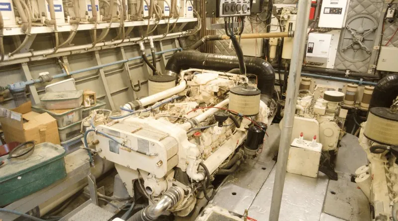 Slide: The Image of Engine room of 1991 Custom New York Yachts 88, featuring complex machinery and equipment. - 3