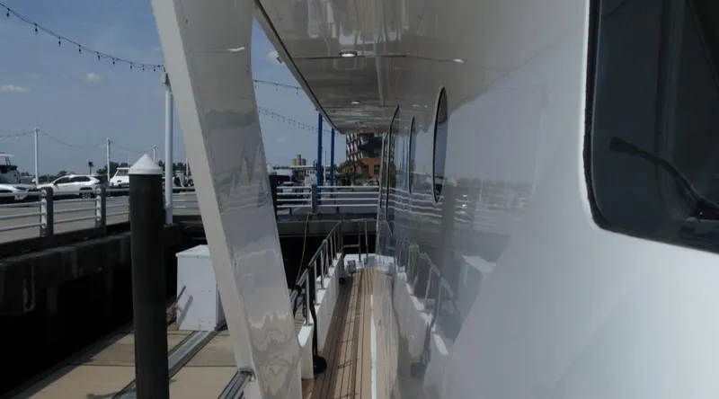 Slide: The Image of Side view of a 1991 Custom New York Yachts 88 docked at a marina. - 31