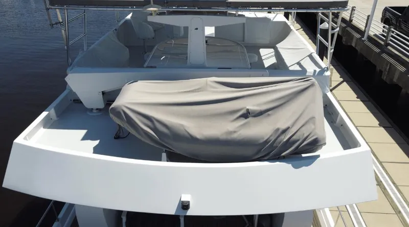 Slide: The Image of Custom New York Yachts 88, 1991 model, docked with covered equipment on deck. - 39