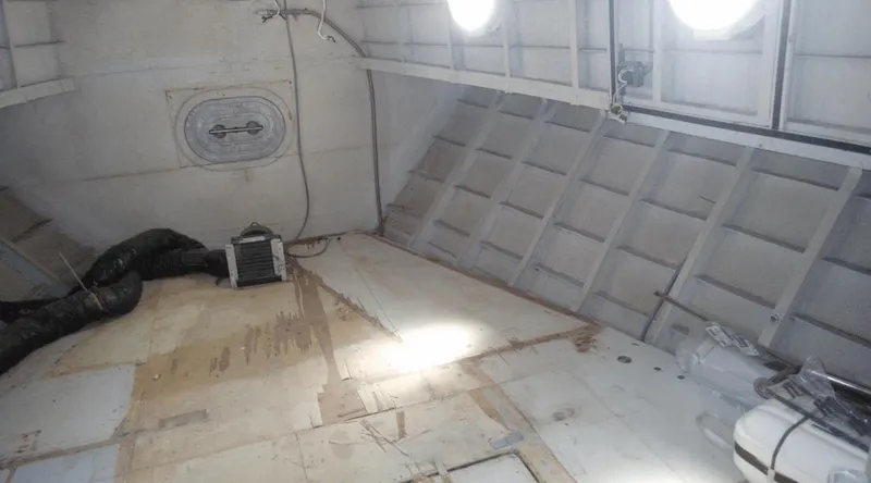 Slide: The Image of Interior of a 1991 New York Yachts 88, showing unfinished cabin space. - 6