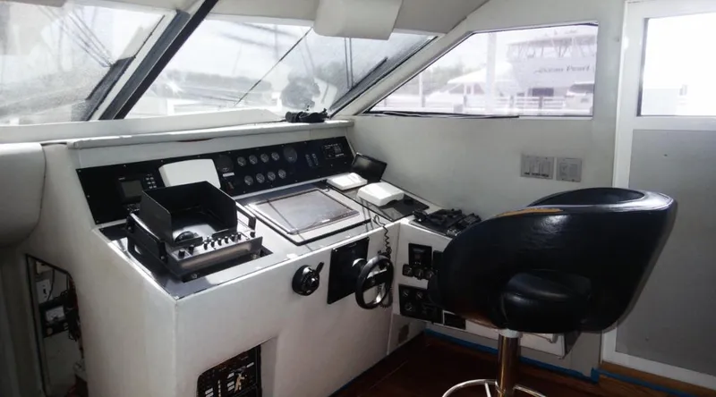 Slide: The Image of Pilothouse of 1991 Custom New York Yachts 88 with navigation controls and captain's chair. - 9