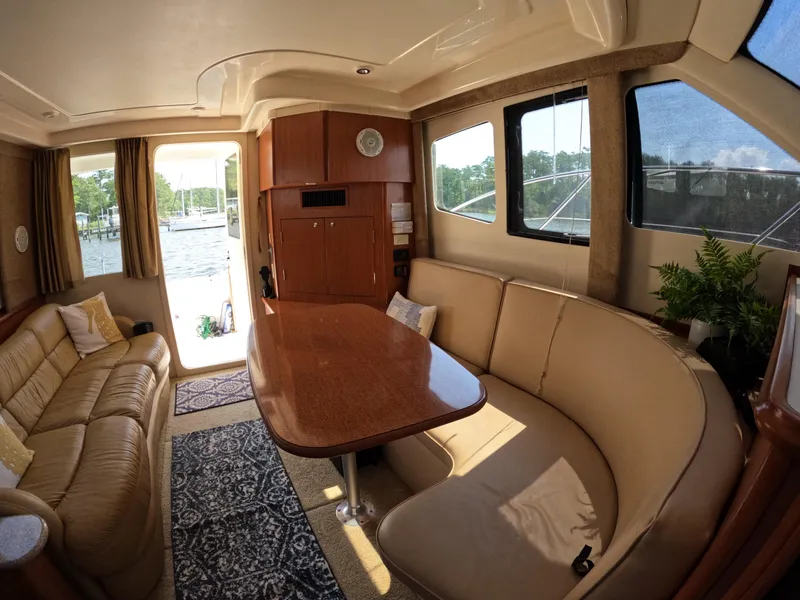 Slide: The Image of Interior of 2008 Silverton 33 Convertible yacht with elegant seating and dining area. - 10