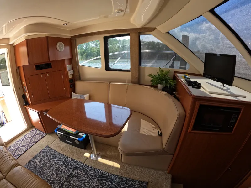Slide: The Image of Interior of 2008 Silverton 33 Convertible yacht with dining area and windows. - 11