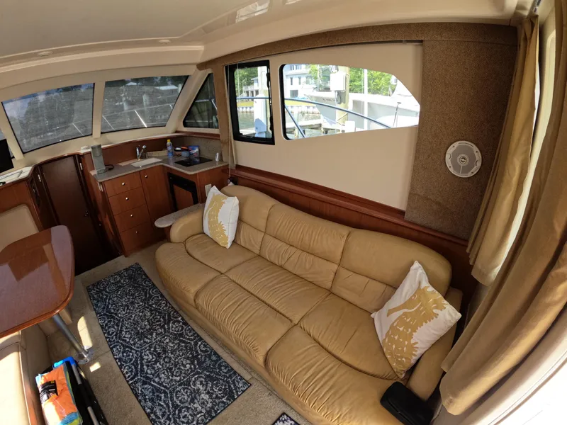 Slide: The Image of Interior of 2008 Silverton 33 Convertible yacht with beige sofa and kitchenette. - 14