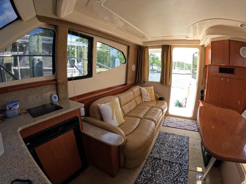 Slide: The Image of Interior of 2008 Silverton 33 Convertible yacht with beige sofa and kitchenette. - 16