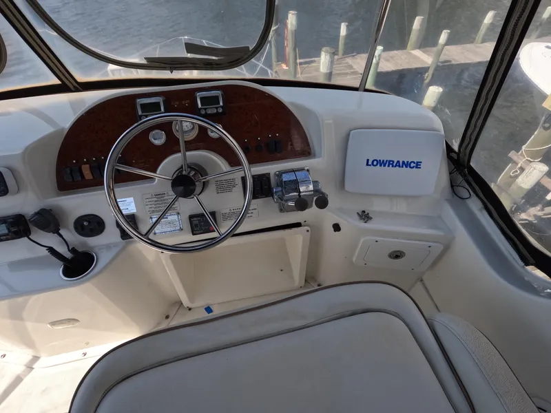 Slide: The Image of 2008 Silverton 33 Convertible boat helm with steering wheel and Lowrance navigation system. - 9