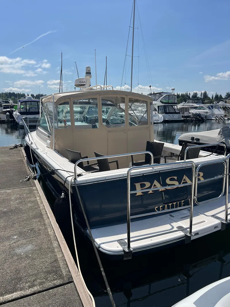 Slide: The Image of 2006 Tiara Yachts 2900 Coronet docked at marina under clear blue sky. - 10