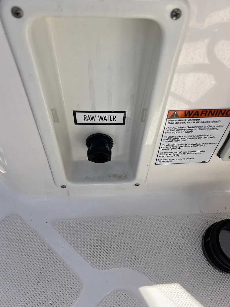 Slide: The Image of 2006 Tiara Yachts 2900 Coronet raw water intake with warning label. - 13