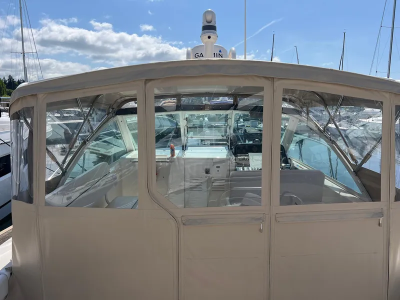 Slide: The Image of 2006 Tiara Yachts 2900 Coronet with enclosed cockpit, docked under a clear sky. - 14