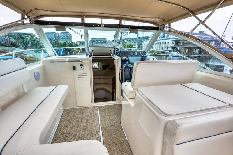 Slide: The Image of 2006 Tiara Yachts 2900 Coronet interior with white seating and helm, docked at marina. - 15