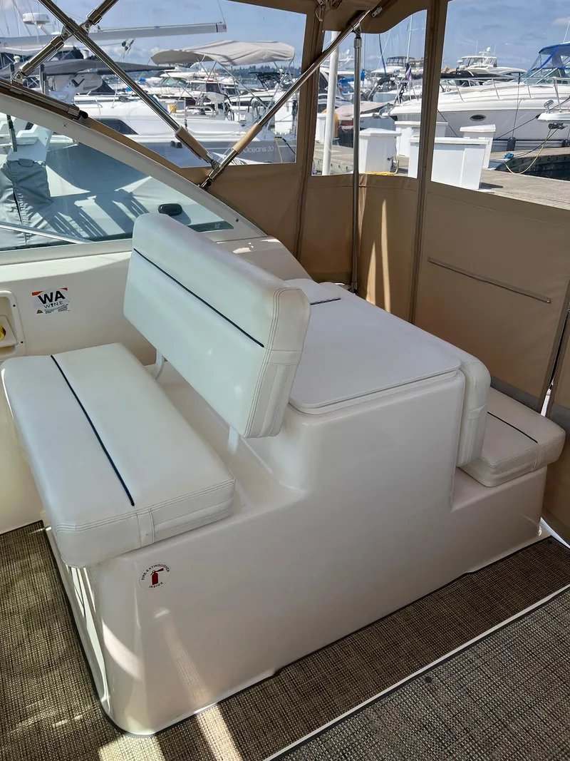 Slide: The Image of 2006 Tiara Yachts 2900 Coronet interior with white seating at marina. - 18