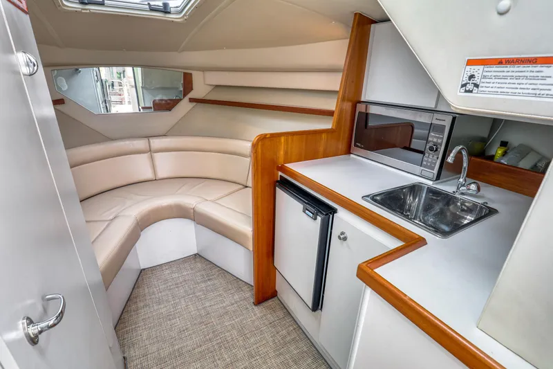 Slide: The Image of 2006 Tiara Yachts 2900 Coronet interior with kitchenette, sink, and seating area. - 22