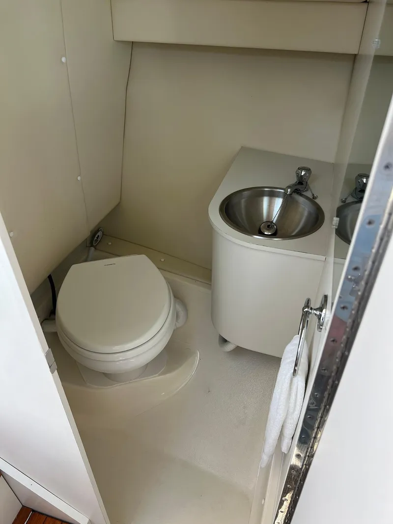 Slide: The Image of Compact bathroom in 2006 Tiara Yachts 2900 Coronet, featuring toilet and stainless steel sink. - 28