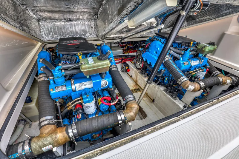 Slide: The Image of Engine compartment of a 2006 Tiara Yachts 2900 Coronet, showcasing dual blue engines. - 29