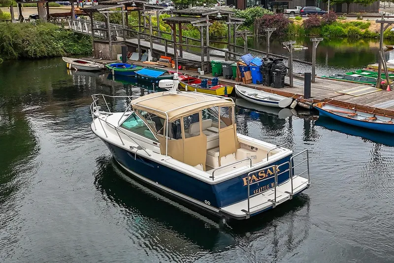 Slide: The Image of 2006 Tiara Yachts 2900 Coronet docked at a marina with surrounding boats. - 3
