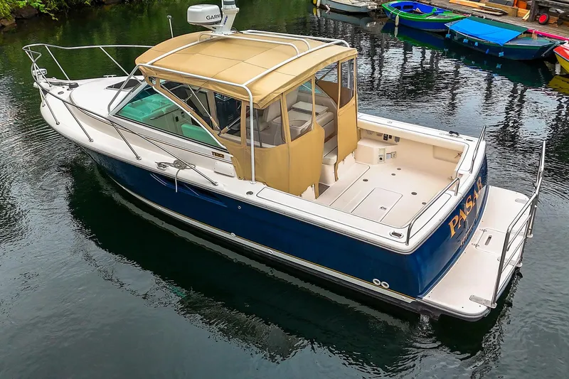 Slide: The Image of 2006 Tiara Yachts 2900 Coronet boat with tan canopy on calm water. - 5