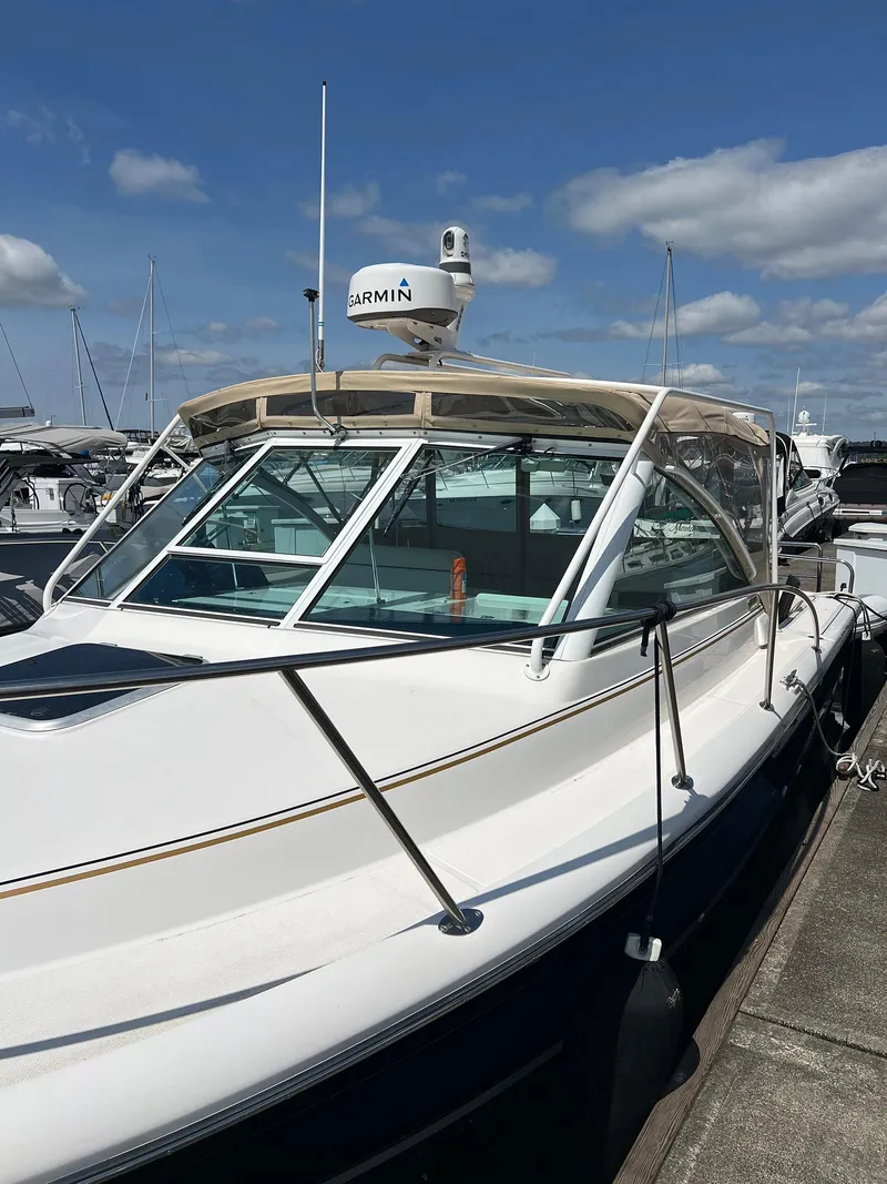 Slide: The Image of 2006 Tiara Yachts 2900 Coronet docked, featuring Garmin equipment under a clear blue sky. - 9
