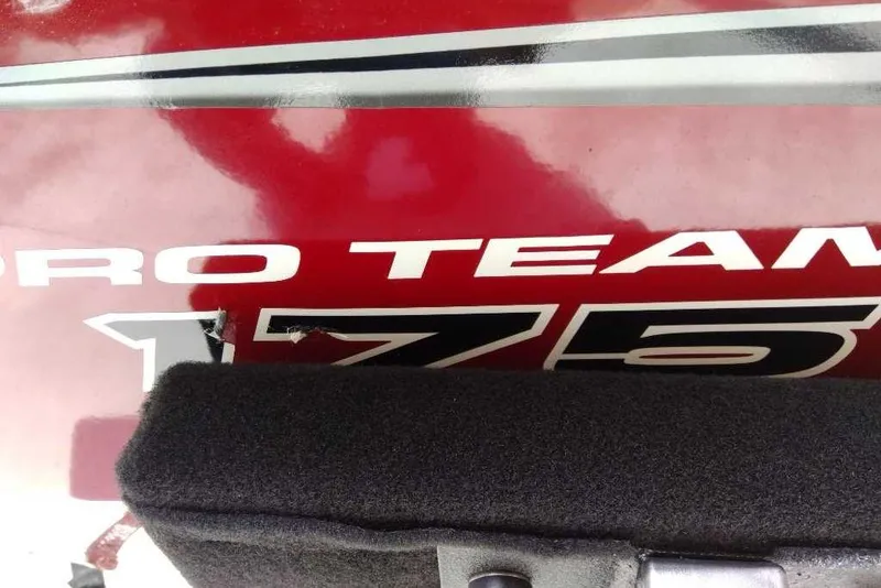 Slide: The Image of 2025 Tracker Pro Team 175 boat logo on a red surface. - 65